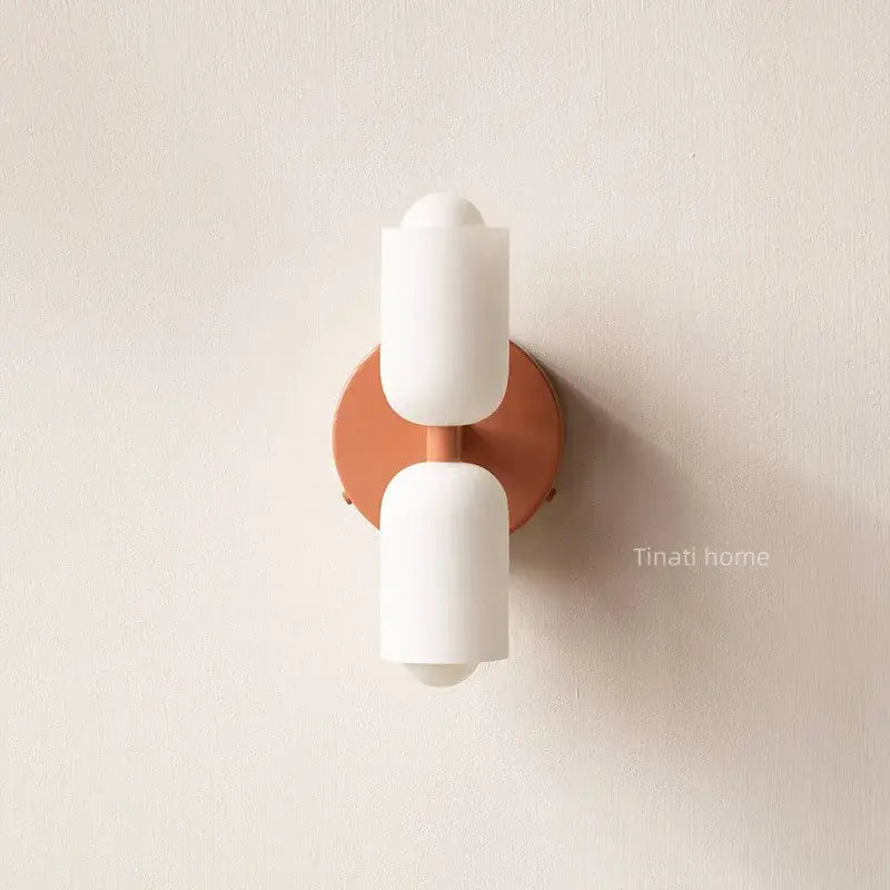 Modern minimalist wall lamp with two white frosted glass shades on a copper-toned base decorbites french cream double
