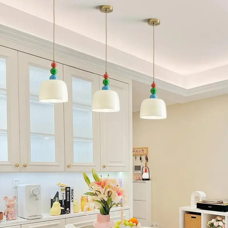 Three pendant lights with white dome-shaped shades and colorful beads in a french cream style chandelier for bedroom decorbites french cream