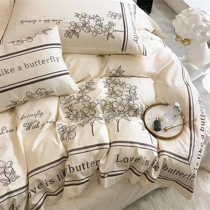 Cream-colored bedding set with black floral and love is like a butterfly text in decorbites french embroidered cotton design