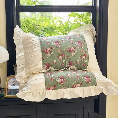A soft sage green pillow with pink and white roses framed by cream ruffled fabric in decorbites french flowers lace bedding set