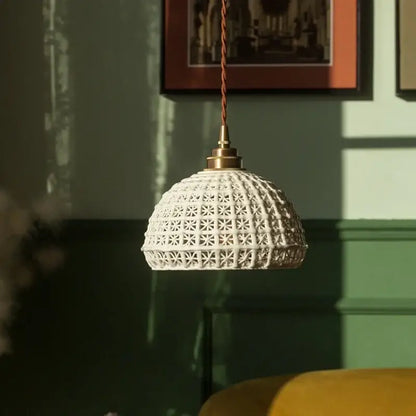 White ceramic pendant light with geometric star pattern and brass hardware for decorbites french minimalism ceramic dining room