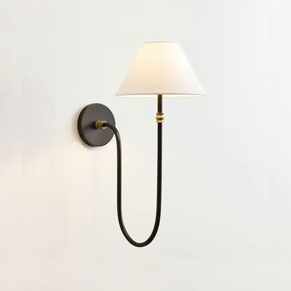 Black wrought iron sconce with brass accents and white fabric shade complementing french minimalist pendant light fabric shades