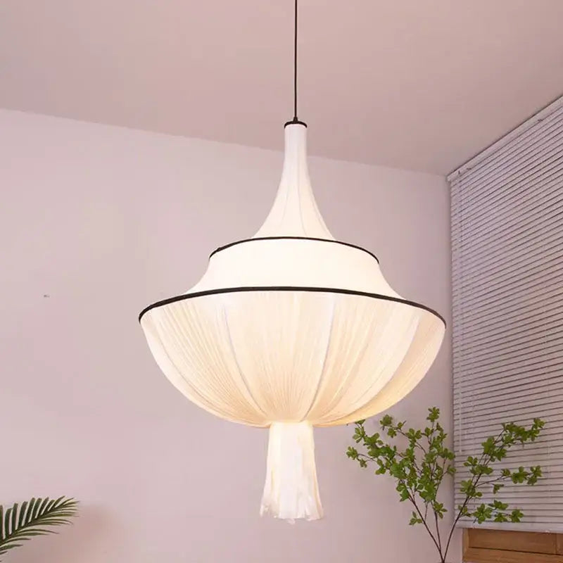 A modern white pendant lamp with soft pleated silk shade and black trim for decorbites french minimalist living room decor