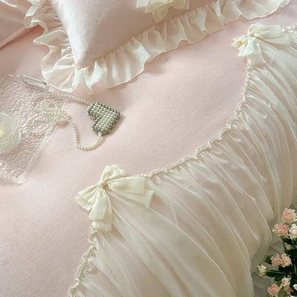 Cream-colored satin pillow with delicate ruffled edges and bow from decorbites french princess lace bedding set