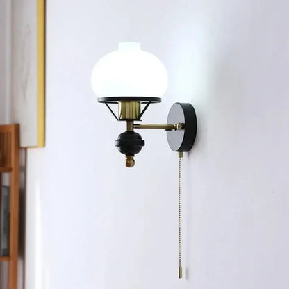 French retro wall lamp with frosted white glass globe black and brass metal accents for living room use