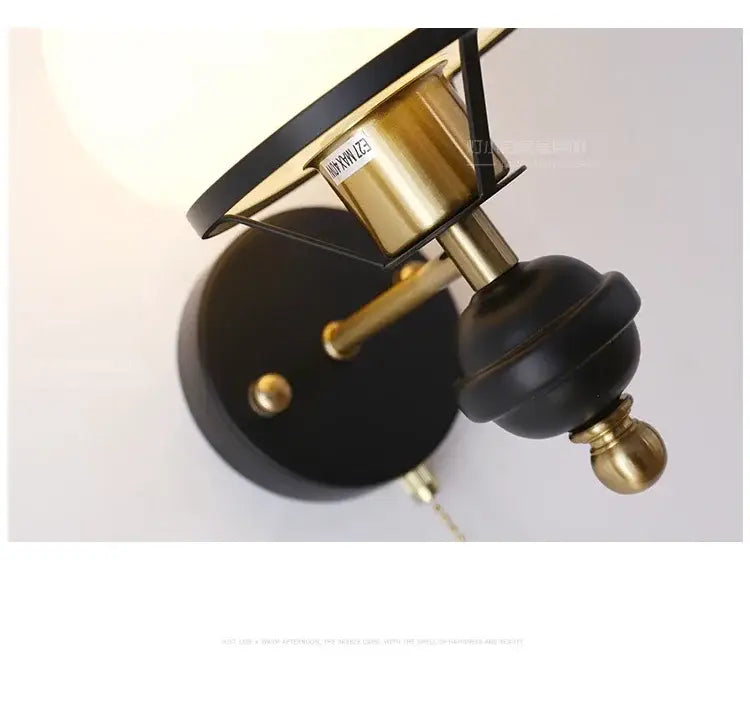 Black and brass french retro wall lamp with matte black base and off-white shade for living room use