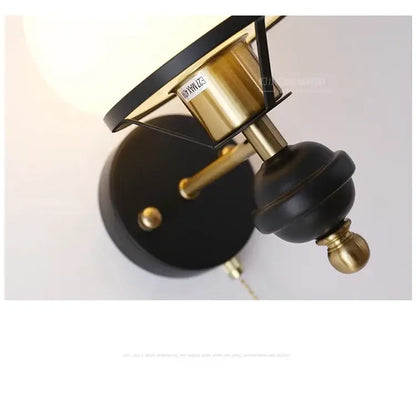 Black and brass french retro wall lamp with matte black base and off-white shade for living room use