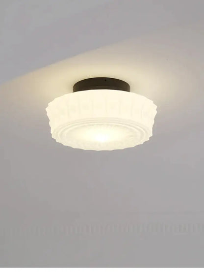 Frosted white glass ceiling light with dark metal base and ridged design in decorbites french retro shanghai style