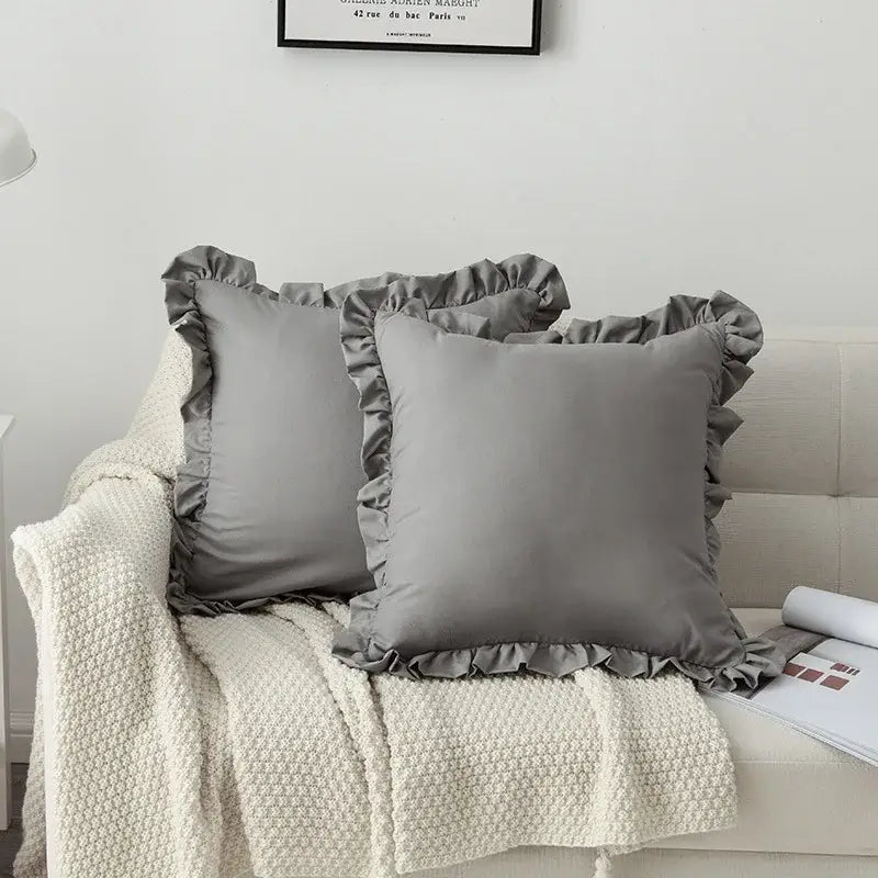 Gray satin french ruffle pillow case with ruffled edges on couch with cream knit blanket decorbites french ruffle