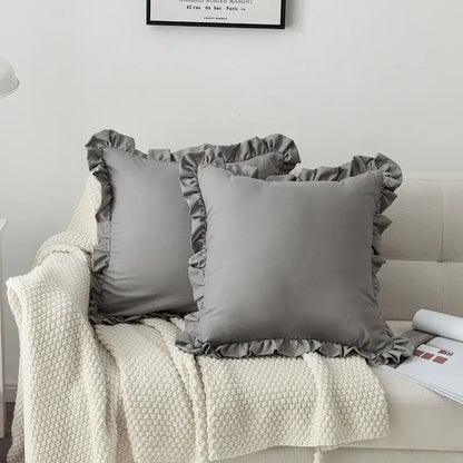 Gray satin french ruffle pillow case with ruffled edges on couch with cream knit blanket decorbites french ruffle