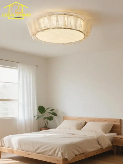 Cream-colored circular ceiling light with sheer ruffled fabric shade and warm glow decorbites cream wind led for bedroom