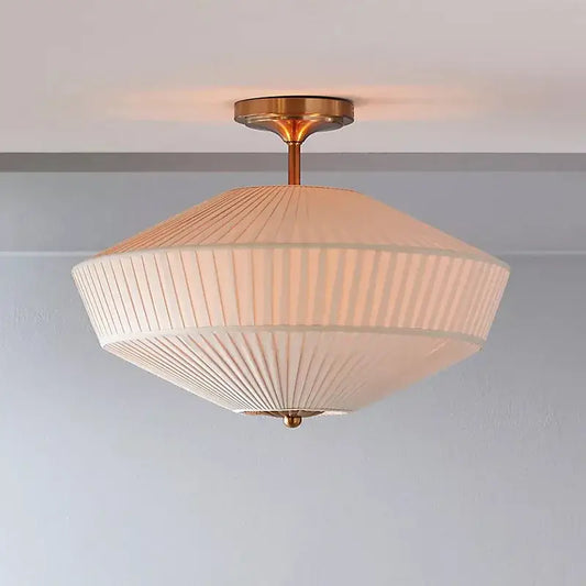 Cream-colored pleated fabric ceiling lamp with brass finish central stem by decorbites french style fabric lighting