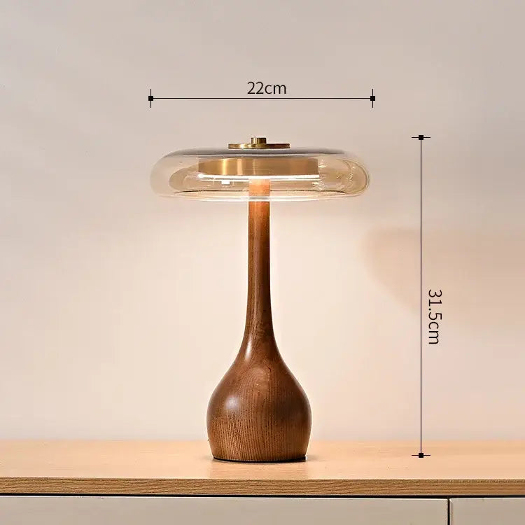 A French style walnut table lamp with a warm wooden base and translucent glass dome shade for bedroom use