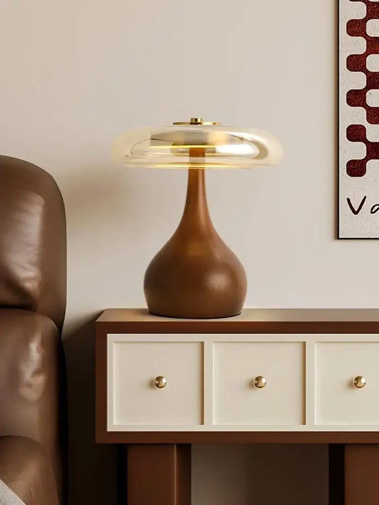 Sleek french style walnut table lamp with warm amber wooden base and translucent glass dome for bedroom use
