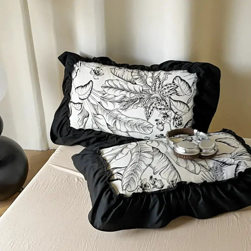 Black ruffled pillow sham with intricate botanical design from french vintage black and cream duvet cover set