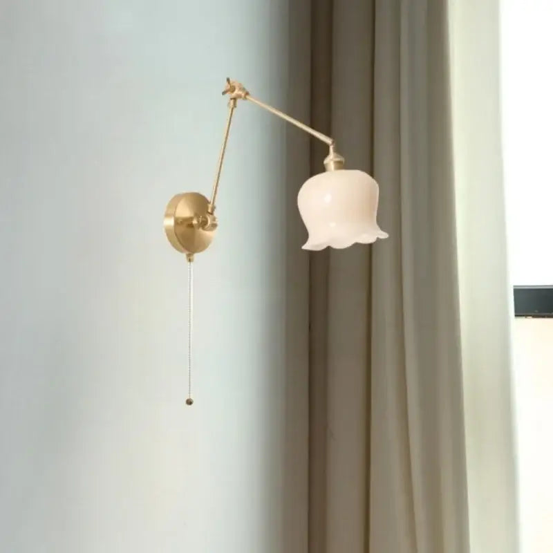 Delicate gold-toned adjustable wall lights with pale pink glass shade cream resin led decorbites cream resin sconce