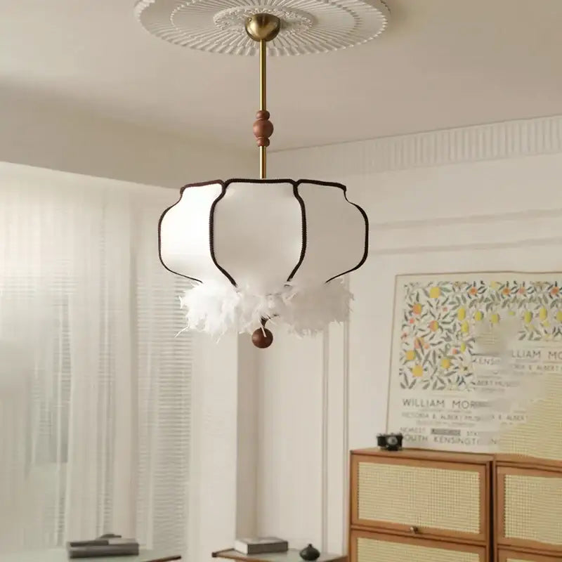 A french vintage fabric chandelier with cream delicate fabric, black trim, and feather accents for dining room decorbites french vintage
