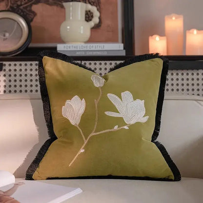 Olive green velvet pillow with white vintage magnolia embroidery and black fringe trim for decorbites french vintage bedroom