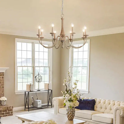 Antique white wrought iron chandelier with six candle-style lights in french vintage wooden dining room pendant light