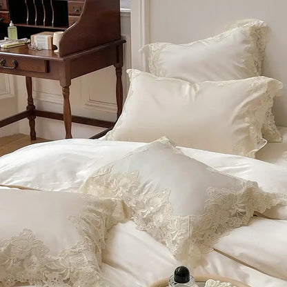 Cream-colored satin pillowcases with delicate floral lace trim in french wedding chic bedding set by decorbites french wedding
