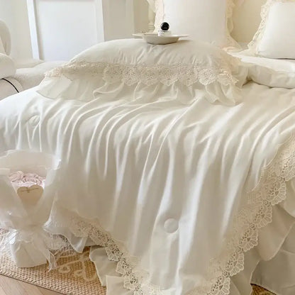 Cream-colored satin bedding set with french wedding lace ruffles and delicate floral embroidery by decorbites french wedding