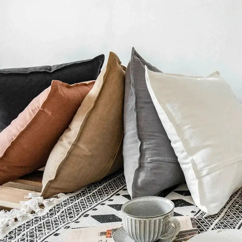 A collection of five muted earth tone fringed linen pillow covers including ivory and grey decorbites linen pillow covers