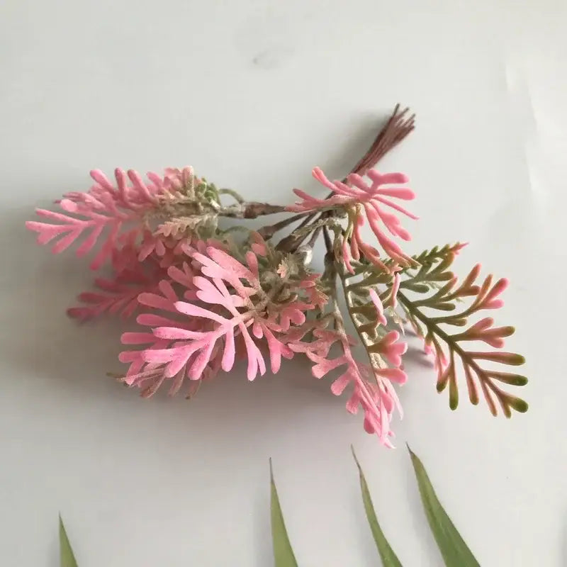 A delicate artificial pink and green fern-like greenery berry stamen bundle made from soft textured material for decorbites decor