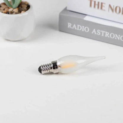 A frosted led candle bulb with a metallic screw base ideal for dining room chandelier lighting by decorbites frosted led