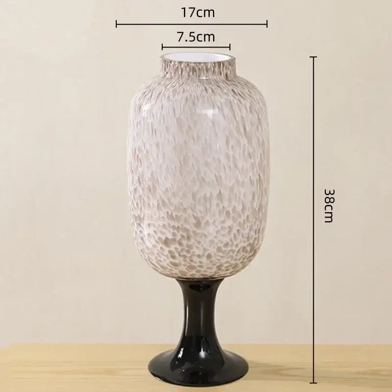 A tall frosted marbled dot texture glass vase with a black pedestal base for living room decor by decorbites dot texture