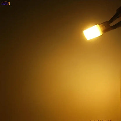 A frosted white ceramic g9 led bulb with a rectangular shape and metallic base for energy-efficient lighting