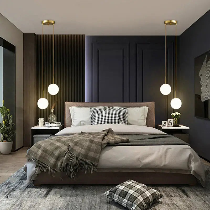 Modern bed with taupe upholstered frame and neutral bedding under a smoke gray frosted globe pendant light for dining room