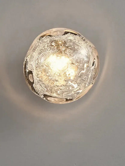 Galaxy blue and amber translucent bubble-filled glass wall sconce lamps emitting a warm glow for living room lighting