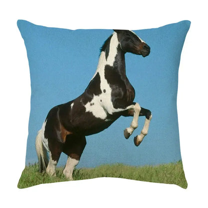 Square linen throw pillow featuring a vivid black and white pinto horse rearing against a bright blue sky decorbites galloping horse