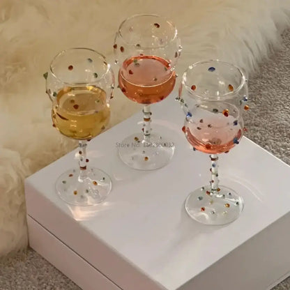 Three clear crystal gem spark coupe goblets with colorful gemstone accents and gold bead detail for dining decorbites gem spark