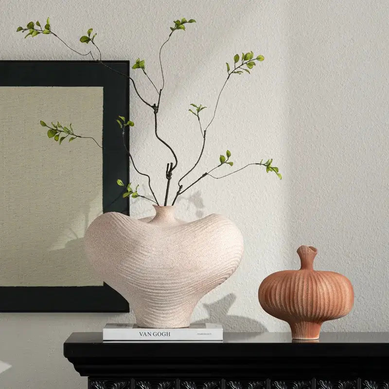 A blush pink geometric abstract ceramic vase with a ribbed textured surface for living room decorbites decor