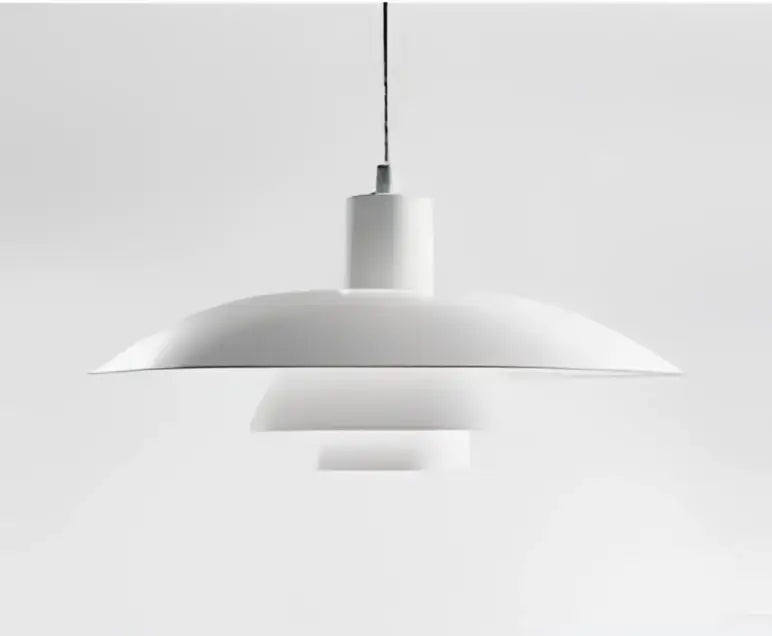 White minimalist pendant light with concentric circular shades and amber cream glass for dining room use