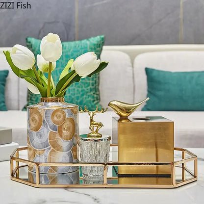 A tall cylindrical vase with gold rim and silver gray bronze patterns holding white tulips for decorbites brass color tissue box living room decor