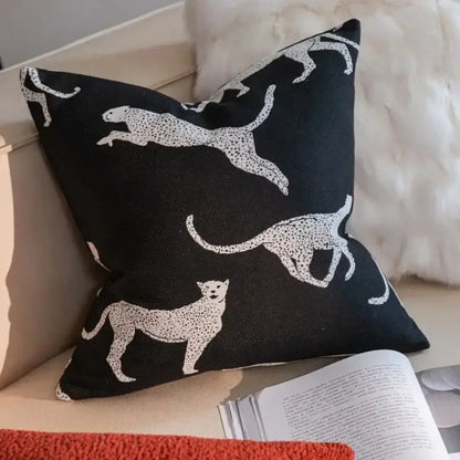 Black cushion with white leopard silhouettes and dotted patterns from geometric black and cream jacquard pillow cover set