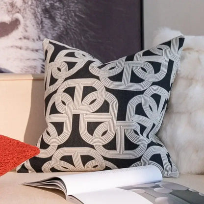 Black and cream geometric jacquard pillow cover set featuring an intricate interlocking pattern for living room use