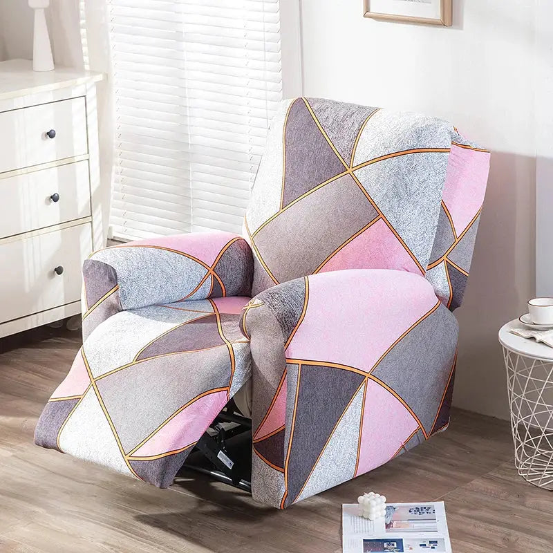 A cozy recliner chair with a stretchy geometric cover in soft pink gray white and gold trim for living room use