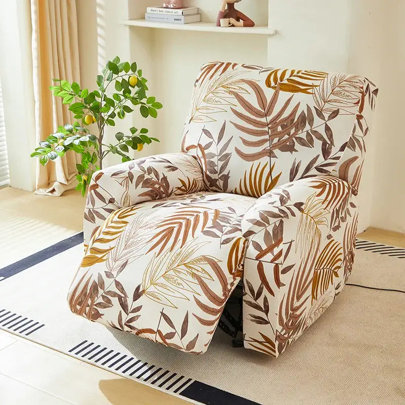 A cozy recliner chair with a stretchy leaf-patterned fabric cover in warm brown gold on creamy white background