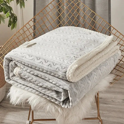 A soft light gray throw blanket with textured knit and plush fleece lining perfect for coral fleece flannel decorbites use