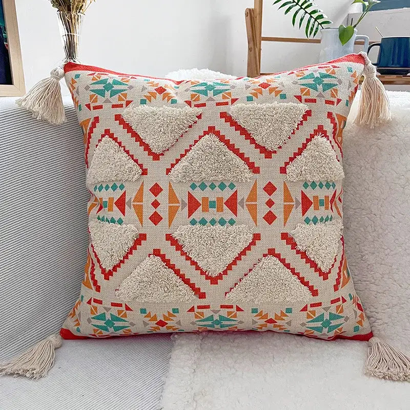 Cream pillow case with decorbites geometric bohemian pattern in red orange teal and mustard yellow tassels for living room decor
