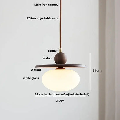 Minimalist pendant light with warm white glass globe and dark walnut wood accents for dining room decorbites clear glass led