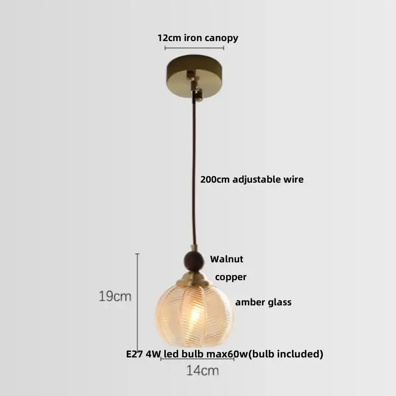 A warm amber glass pendant light with textured spherical shade and copper accents for dining room decorbites clear glass led