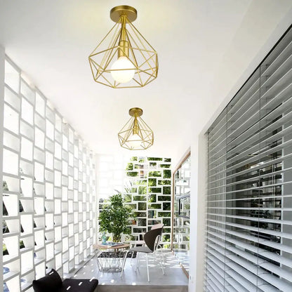 Gold geometric cage iron ceiling light fixture with frosted glass bulbs for dining room exposed bulb lighting