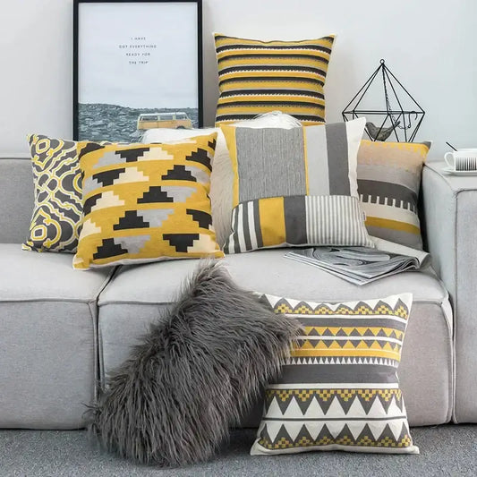 A cozy gray faux fur throw pillow on a sofa with decorbites geometric canvas cotton yellow cushion cover