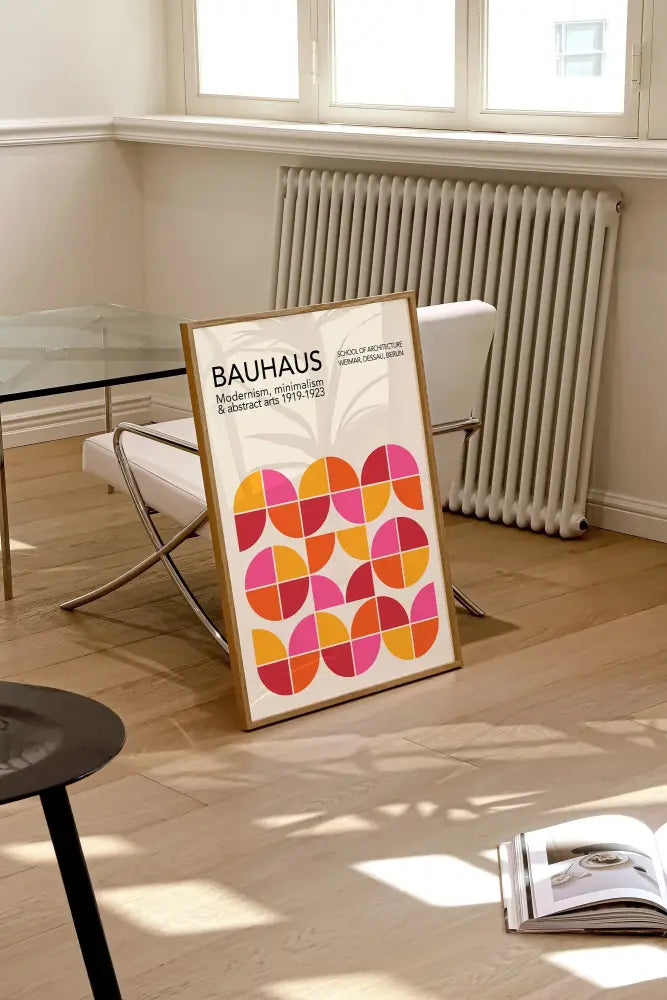 A framed DecorBites™ bauhaus geometric canvas print with vibrant orange and pink circles for modern home decor