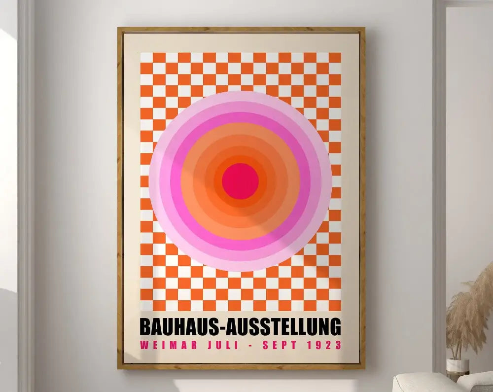 A framed bauhaus geometric canvas print with concentric pink and orange circles on checkered background for home decor