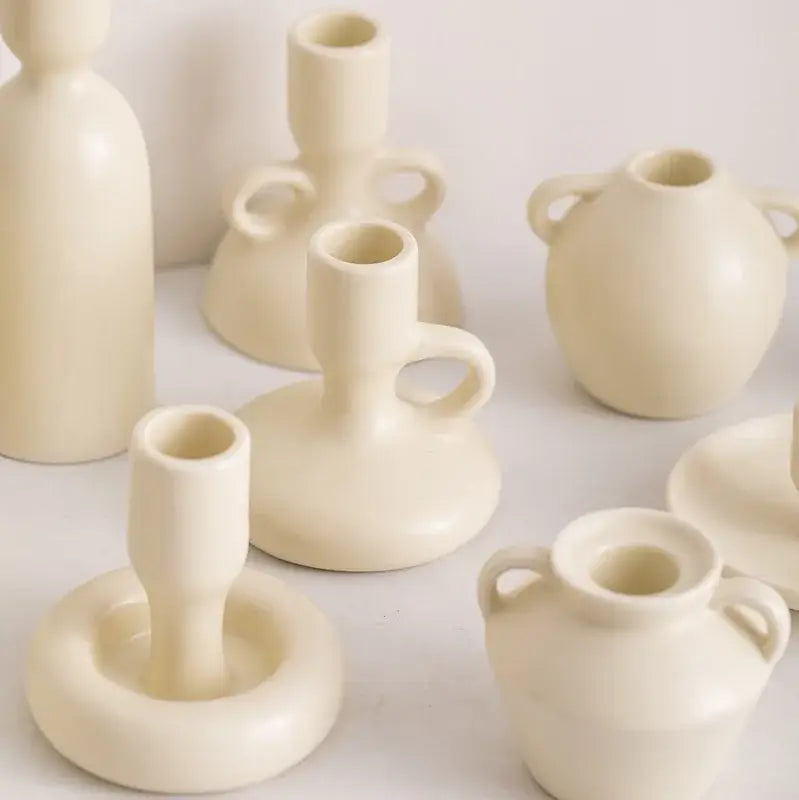 Cream-colored decorbites geometric ceramic candle holder set with smooth minimalist design and handle accents for living room decor